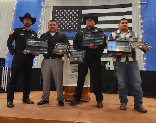Group award photograph with Sheriff James Maiorano III first and Deputy Miguel Bittony third from the left