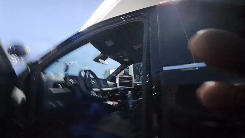 Source thumbnail from Bowman’s response recording beside an open patrol vehicle